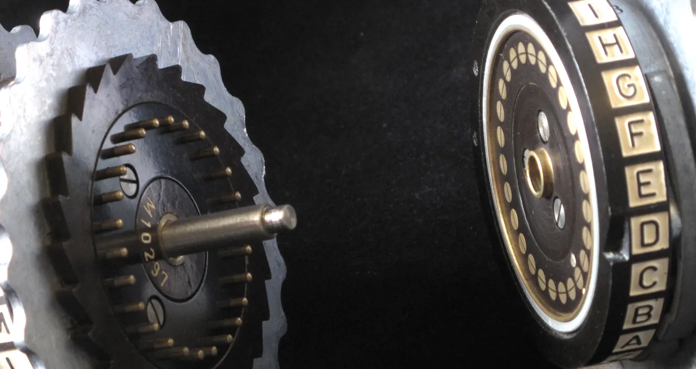 Enigma rotors on their spindle, showing contacts, ratchets and notches.